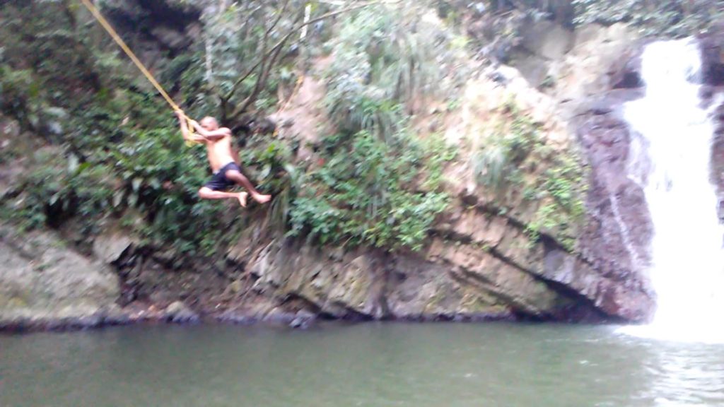 jumping from a rope in a beautiful river in puerto rico