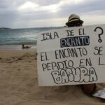 guardian beach cleanup Puerto Rico sign on shore